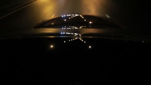 Réflexions lumineuses sur le verre de voiture et le capot de voiture la nuit. Conduite nocturne 