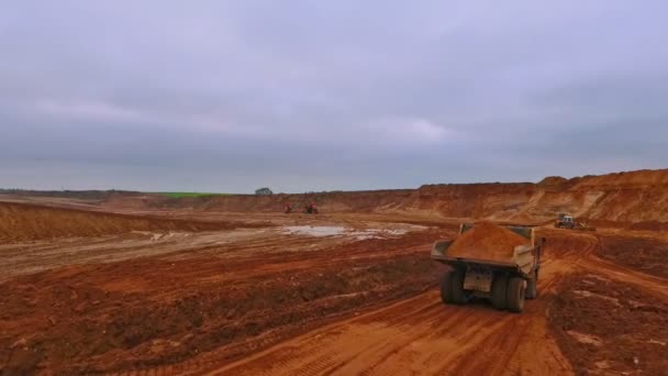 Dumper truck moving along sand quarry. Aerial view of dump truck — Stock Video