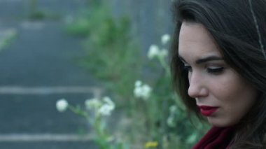 Esmer saç kamera çit kafes arka plan üzerinde seyir ile kadın portre
