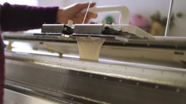 Erkek üzerinde makine Tekstil atölyesinde örgü dokuma desen yapma eller