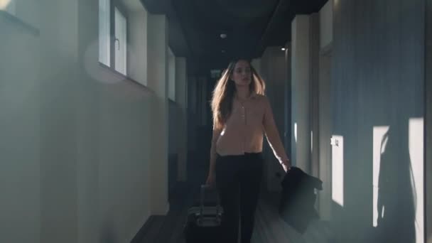 Business woman walking at hotel corridor. Businesswoman arriving in hotel