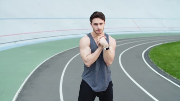 Runner warming up at modern stadium. Sport man stretching at stadium — Stock Footage Runner warming up at modern stadium. Sport man stretching at stadium Stock Footage