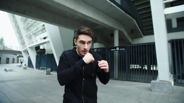 Hombre de combate entrenando boxeo ponche en la calle urbana. Primer plano hombre boxeo al aire libre — Vídeo de stock