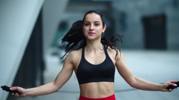 Ajuste mujer saltar con saltar la cuerda al aire libre. Atleta mujer practicando salto — Vídeos de Stock