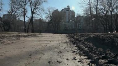 Closeup dirt road at new building background. Offroad way near real estate.
