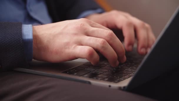 Closeup male hands typing on notebook keyboard at home office. Man using laptop — Stock Video