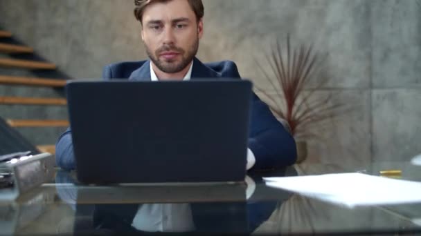 Un uomo d'affari concentrato che lavora al portatile in ufficio. Top manager lettura del testo. — Video Stock