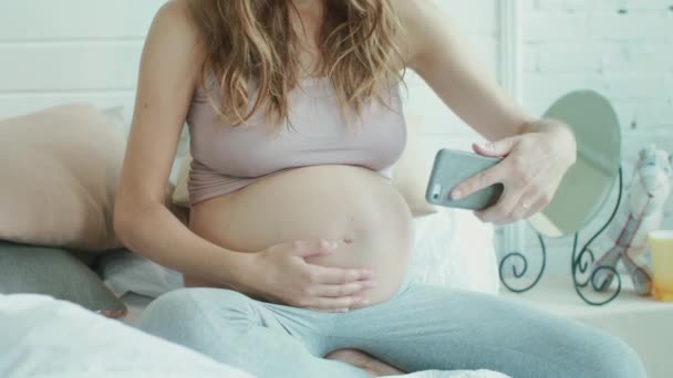 Closeup pregnant woman taking photo of belly. Belly mother showing thumb up — Stock video