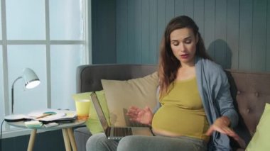 Tired pregnant businesswoman throwing mobile phone in slow motion