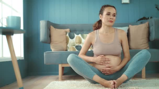 Closeup young pregnant woman relaxing after worout at home. — Stock Video