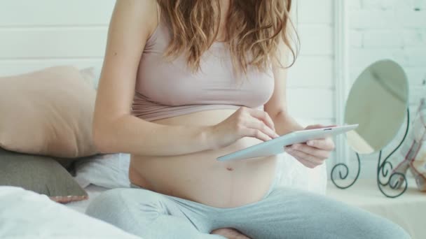 Closeup unrecignized barriga mãe servfing em comprimido. Mulher grávida relaxante . — Vídeo de Stock