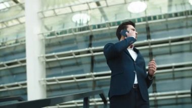 Closeup businessman talking smartphone. Businessman smiling with phone outdoors