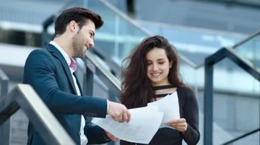 Closeup couple celebrating victory. Business partners discussing documents