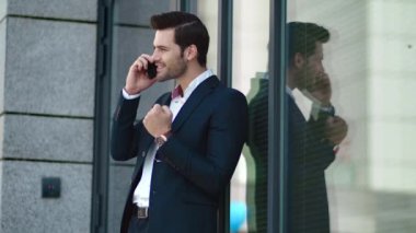 Closeup businessman talking phone outside. Business man using smartphone