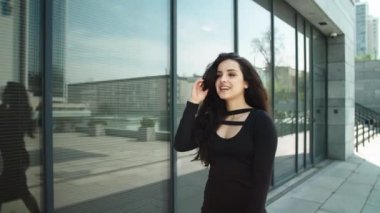 Closeup woman touching hair at street. Business woman looking away outdoors