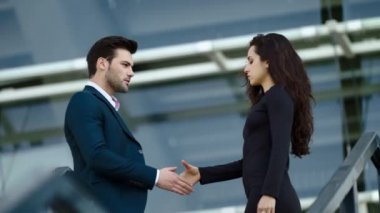 Closeup couple shaking hand at street. Couple looking at each other outside