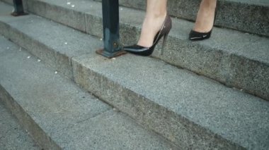 Closeup female feet going downstairs in shoes. Woman walking in high heel shoes