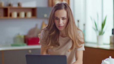 Businesswoman receiving good news on laptop. Freelancer working at home