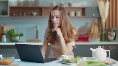 Businesswoman using laptop at home office. Woman working on laptop at workplace