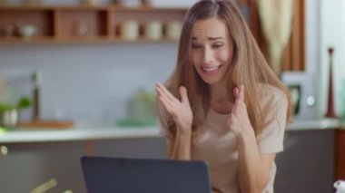 Businesswoman getting good news on laptop screen at remote office in slow motion