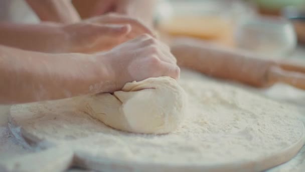 Woman and girl kneading dough on kitchen in slow motion — Stock Video