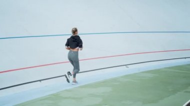 Spor stadyumunda engelli kadın koşucu eğitimi. Spor pistinde koşan kadın