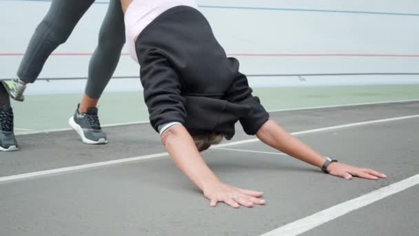 의족을 가진 운동 선수들은 요가를 트랙 위에서 연습 합니다. 옥외 훈련을 받는 여자 — 비디오