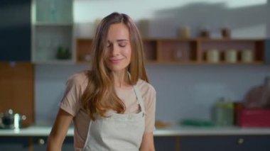 Modern mutfakta dans eden pozitif bir kadın. Ev hanımı mutfakta yemek pişiriyor.