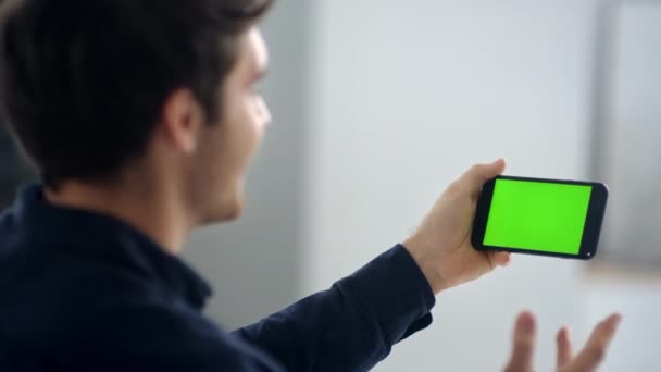 Cheerful making video talk on green screen mobile phone in slow motion — Stock videók