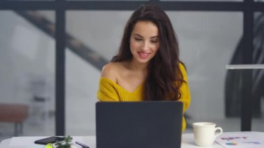 Positive woman getting good news on email. Pretty businesswoman winning project.