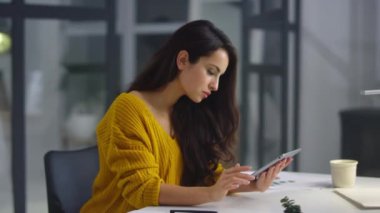 Businesswoman analyzing information on pad. Woman touching green screen on pad