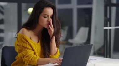 Tired business woman reading documents on computer. Sad girl finding mistake