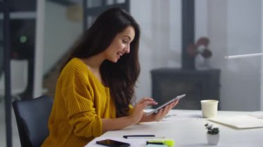 Successful businesswoman making winner gestures in modern office.