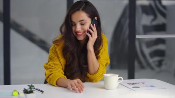 Closeup smiling businesswoman talking mobile phone in office