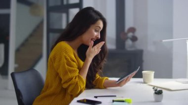 Cheerful business woman touching pad screen. Pretty girl surfing internet on pad
