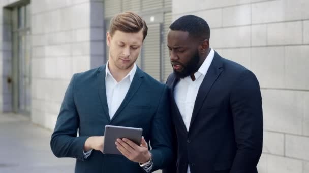 Empresários trabalhando em tablet na cidade. Homens de negócios usando touchpad fora — Vídeo de Stock
