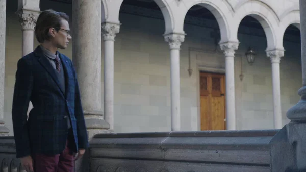 Φοιτητής που περπατάει σε κτίριο κολεγίου. Ο άνθρωπος κοιτάζει γύρω από διάδρομο στο πανεπιστήμιο — Φωτογραφία Αρχείου