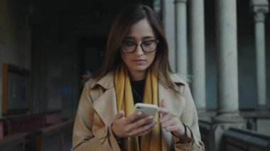 Öğrenci internette internette geziniyor. İş kadını dışarıda cep telefonuyla yazı yazıyor.