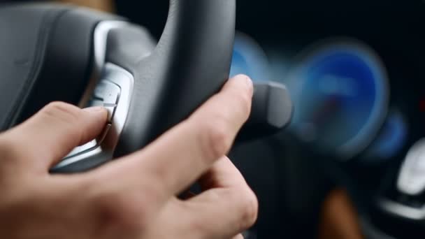 Close up male hand pushing buttons on wheel. Man fingers touching buttons in car — Stock Video