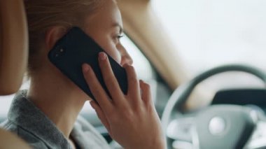 Direksiyon başında telefon kullanan kadının arka görüntüsü. Kız akıllı telefonu arıyor.