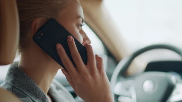 Bakifrån på kvinnan som använder telefonen bakom ratten. Flicka ringer smartphone — Stockvideo