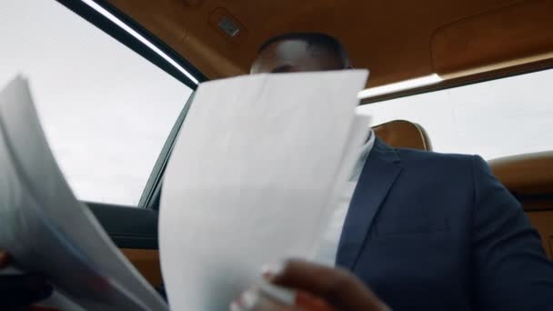 Primer plano leyendo documentos en el coche. Empresario disfrutando del éxito en el asiento trasero — Vídeo de stock