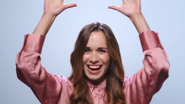 Businesswoman showing yes gesture in studio. Woman smiling on blue background — Stock Video