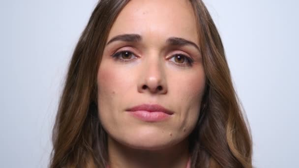 Sick business woman sneezing on blue background. Girl smiling at camera — Stock Video