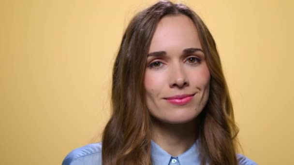 Mulher sorridente a dançar no estúdio. Menina cantando música no fundo amarelo — Vídeo de Stock