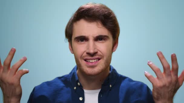 Displeased man gesturing with hands at camera. Annoyed guy posing in studio — Stock Video