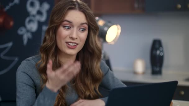 Emotional businesswoman making video call on laptop computer at home office. — Stock Video