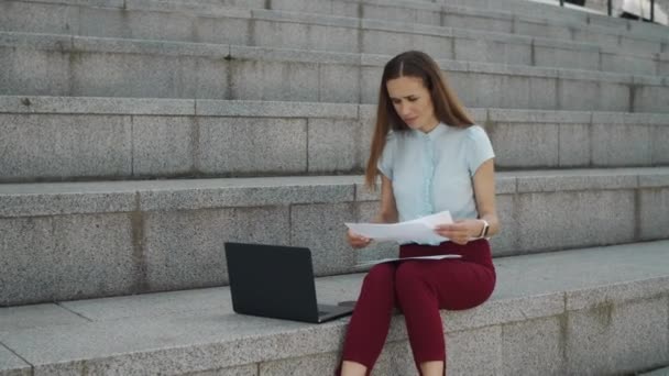 ラップトップコンピュータ上の文書から情報をチェックする驚くべきビジネス女性 — ストック動画