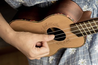 genç kadın ukulele üzerinde oyun görünümü kapatın