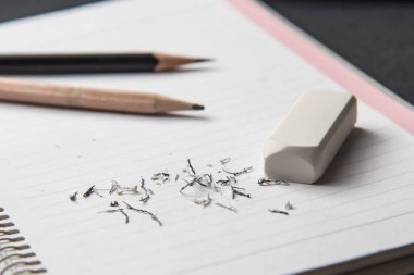 Beyaz silgiyi kapat ve boş notebbok üzerine bulanık kalemler yaz